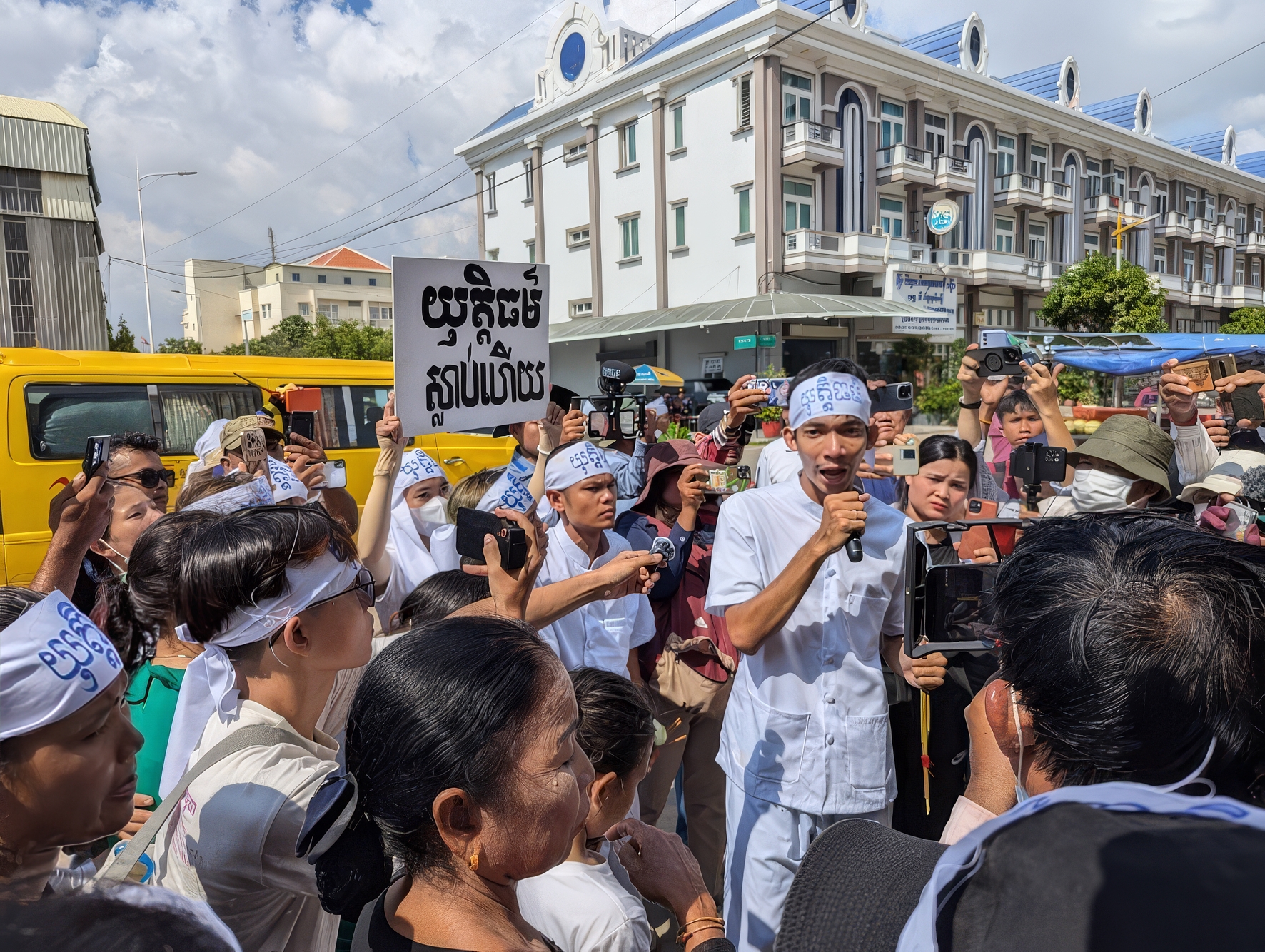 Mother Nature Cambodia activists Thun Ratha and Ly Chandaravuth (holding mic) speaking to supporters before the Phnom Penh Capital Court announced a verdict in their case on July 2, 2024, credit: LICADHO