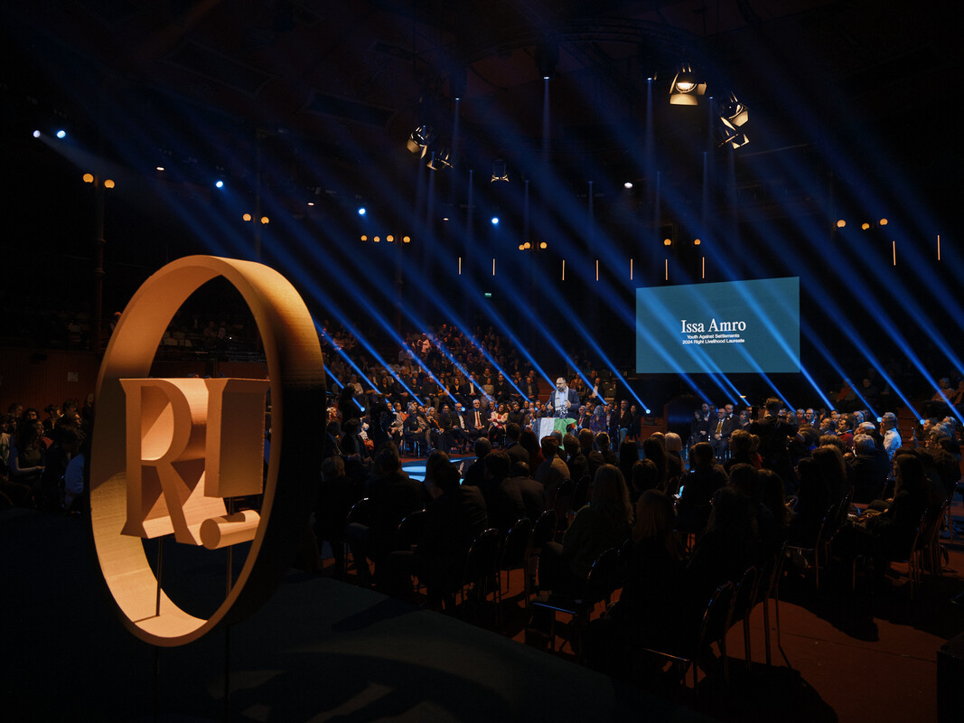Wide shot of the 2024 Right Livelihood Award Presentation, with Laureate Issa Amro standing on stage in the middle.