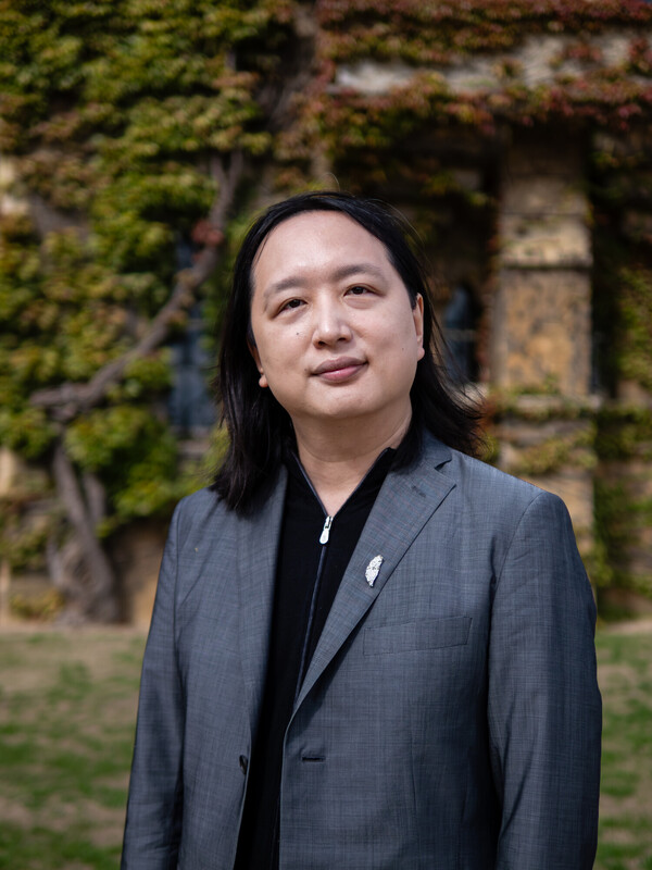 2025 Right Livelihood Laureate Audrey Tang standing in front of a building, looking into the camera.